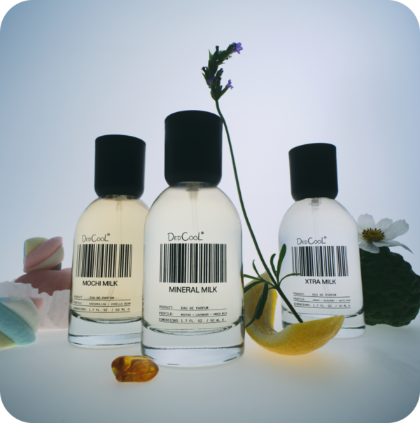 Three perfume bottles labeled 'Mochi Milk', 'Mineral Milk', and 'Xtra Milk' with a bar code on a light background.